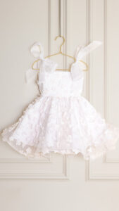 girls flower dress sewing pattern with smocked bodice and bow straps, toddler party dress pattern sizes 12 months to 12 years