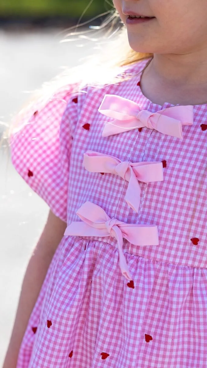 Close-up detail of pink gingham girls dress