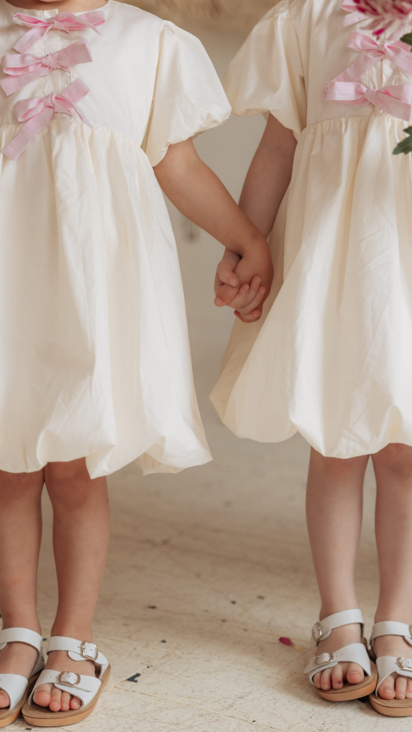 Girls puff dress sewing pattern featuring bubble skirt and bow front bodice