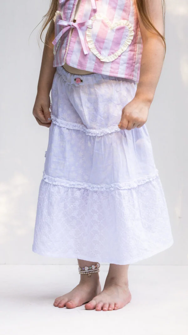 Girls ruffle skirt sewing pattern with gathered tiers and comfortable elastic waistband.